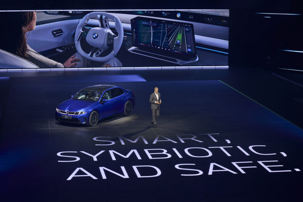 lenkrad-innenraum-bmw-i3-mann-laeuft-vor-blauem-i3